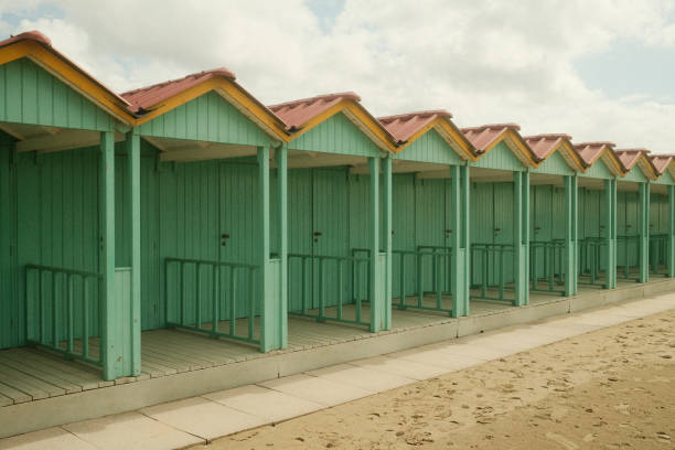 Green cabins on the beach at the sea. Vintage look.