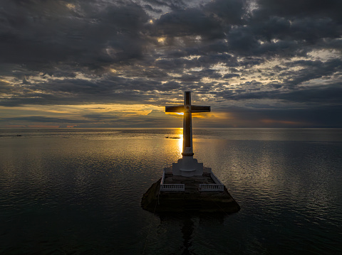 Sunken Cemetery with sunset background in Camiguin Island. Historical landmark in the Philippines. Travel destination. Twilight over the sea.