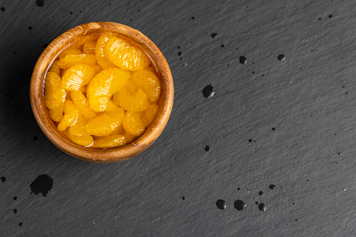canned peeled tangerines in sugar syrup, ripe small slices of tangerines in sweet syrup