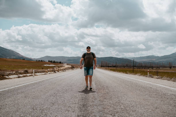 istock A man walking alone the road. Freedom concept 2151128945