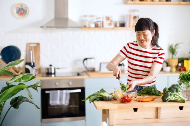 istock Woman preparing salad 2151129535
