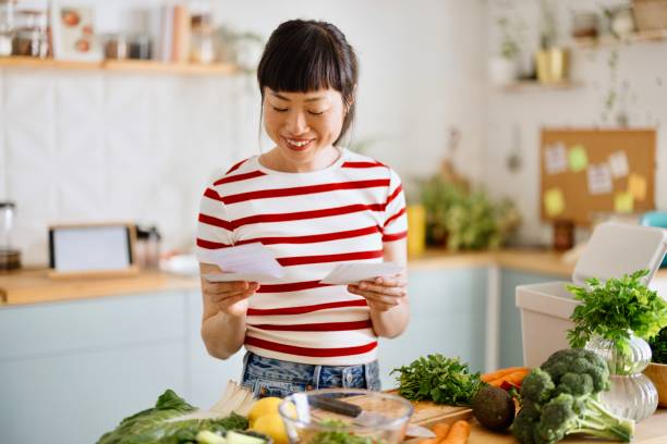 istock Woman using recipe cards while cooking healthy food 2151129543