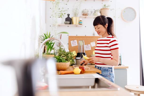 istock Woman preparing fresh food in her kitchen 2151129603