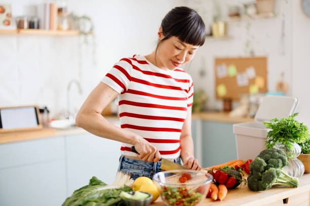 istock Woman cutting vegetables for her salad 2151129616