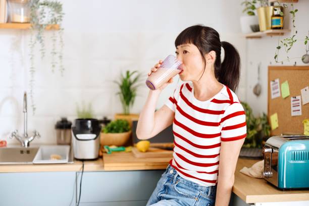 istock Woman drinking healthy smoothie 2151129658