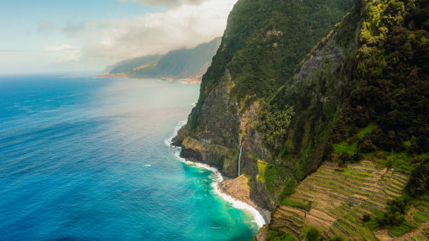 istock Dramatic Aerial View of Waterfall Falling From Mountains Into Ocean on Madeira Island 2151129819
