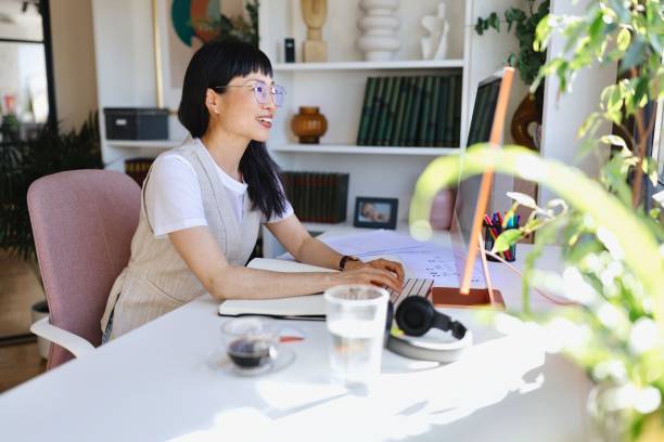 istock Productive female person working from home 2151131249