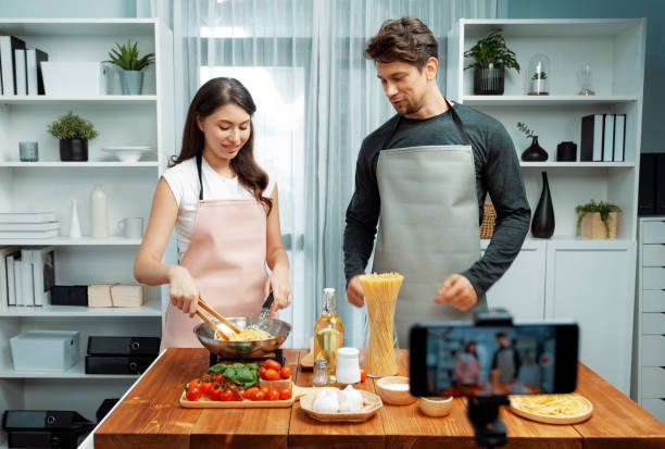 istock Chef influencers cooking special spaghetti recording on smartphone. Postulate. 2151132266