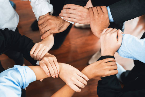 istock Multicultural business people holding hand together in circle. Habiliment 2151134471