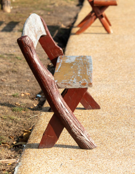 Wooden bench on the sidewalk in the park.