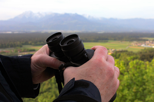Using binoculars to view the Alps
