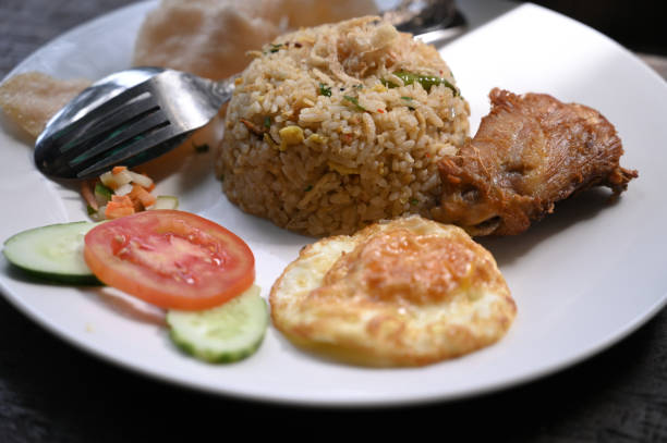 istock Special fried rice served with fried chicken, cucumber and fried egg 2151138584