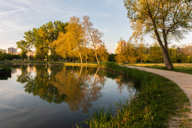 Long exposure shot of the Boating Lake and a public park in Ajka in the morning in springtime.