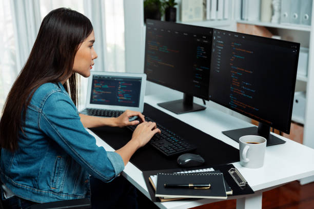 istock Young Asian in IT creating with typing online information on pc. Stratagem. 2151140900