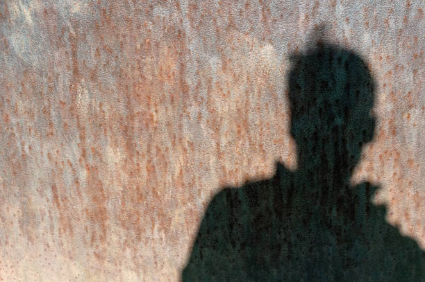 istock rusty sheet metal with the shadow of a man 2151141357