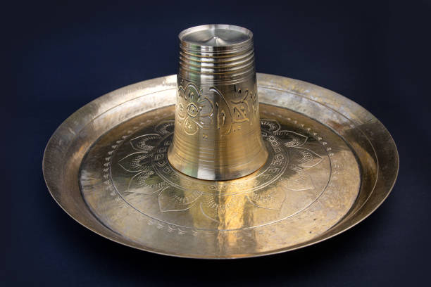 decorated, carved bronze Plate for taking meal. once it was popular serving plate or dish in Bangladesh and indian royal family. food grade kansa plate or thali and glass or water pot.