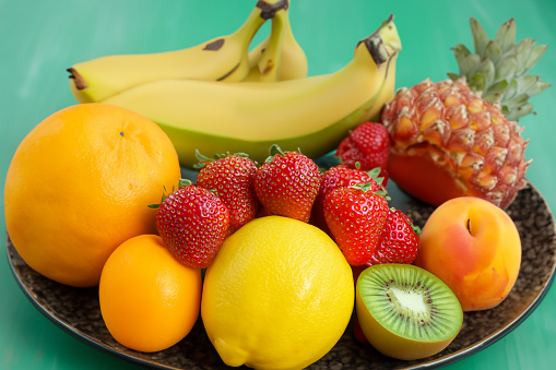 Variation of fruits, banana, strawberry, kiwi, peach, lemon, orange, pineapple