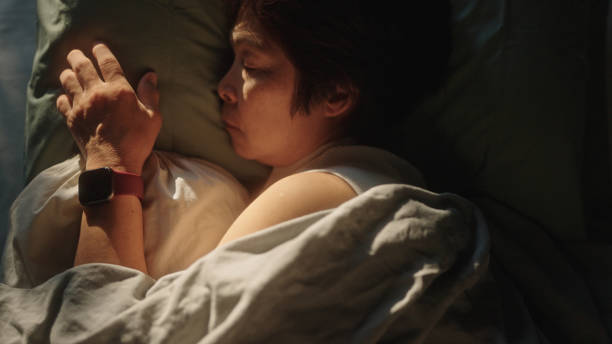 istock Mature woman wear a smart watch while sleeping. 2151151240