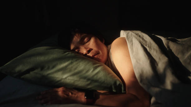 istock Mature woman wear a smart watch while sleeping. 2151151262