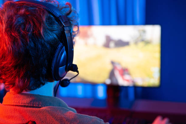 istock Gaming streamer team playing battle game shooting at back side image. Gusher. 2151151434