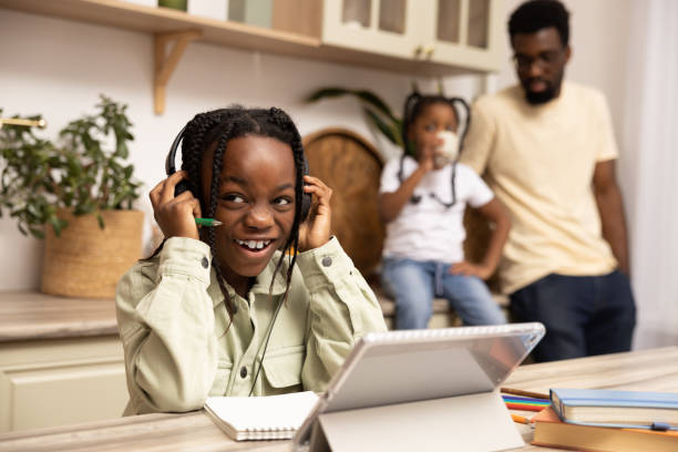 istock Multicultural little girl using digital software on tablet for online education 2151152985