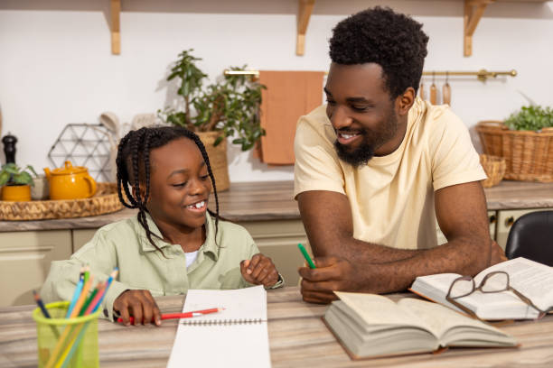 istock Happy father helping his child daughter studying at home 2151153010