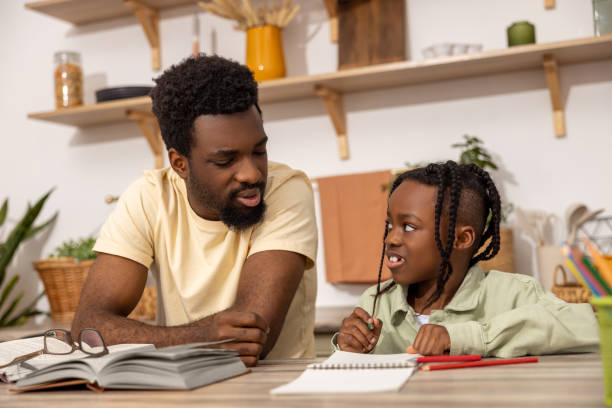 istock African American man with his daughter studying together 2151153016