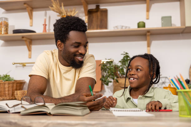istock African American man with his daughter studying together 2151153034
