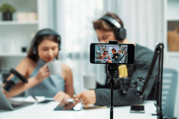 istock Focus on smartphone recording with blurry host channel broadcaster. Postulate. 2151153158
