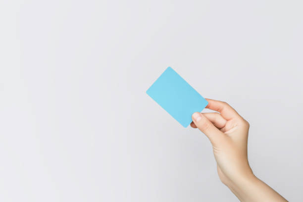 istock hand holding a blue plastic card on a grey background 2151153735
