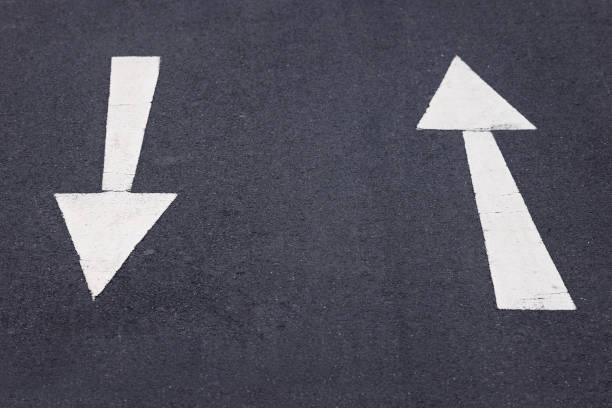 istock Big white arrows on the asphalt back and forth 2151156508