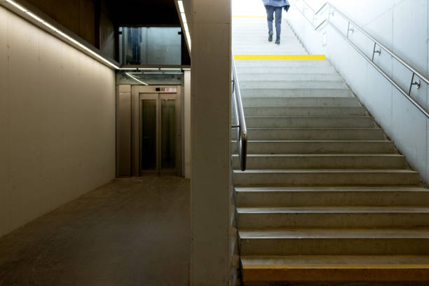 istock Man climbs the Stairs in the underpass. There is an elevator nearby 2151156510