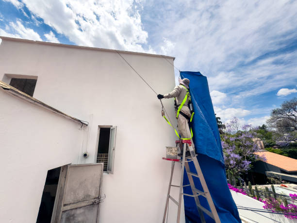 istock Man working painting rooftop at Mexico City 2151157505