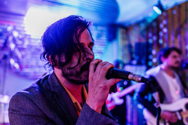 istock Mid adult man singing on a rock show 2151159951