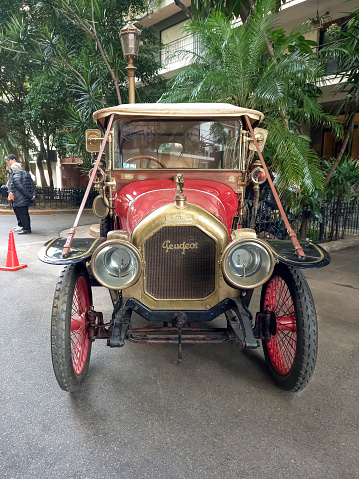 Buenos Aires, Argentina - May 13, 2023: Old red 1910s Peugeot phaeton in the street at an antique car show. Recoleta - Tigre Grand Prix. Front view.