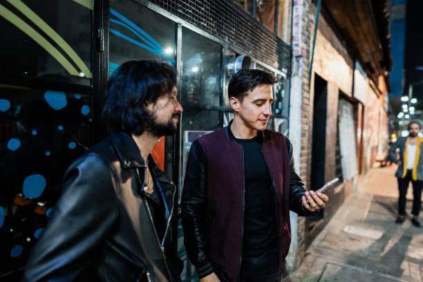 Friends using mobile phone in the city