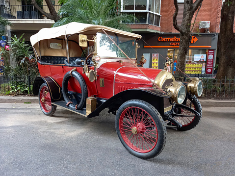 Buenos Aires, Argentina - May 13, 2023: Old red 1910s Peugeot phaeton in the street at an antique car show. Recoleta - Tigre Grand Prix.