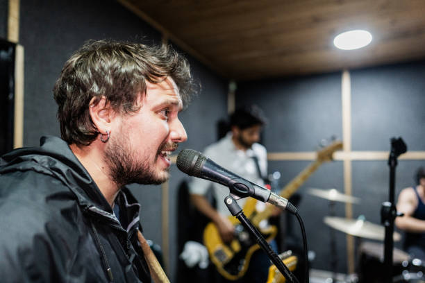 Mid adult man singing at recording studio