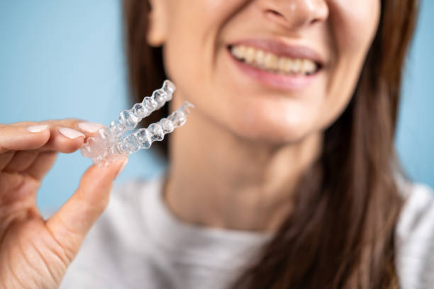istock A woman holding transparent teeth aligners. 2151161345
