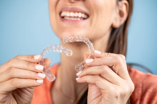 istock A woman holding transparent teeth aligners. 2151161410