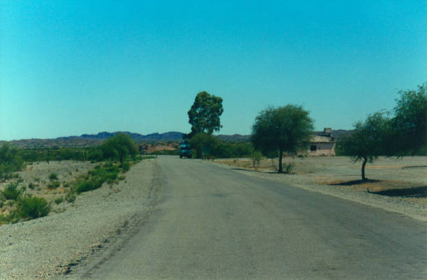 istock Road in the mountain next to a building and a bus. 2151163536