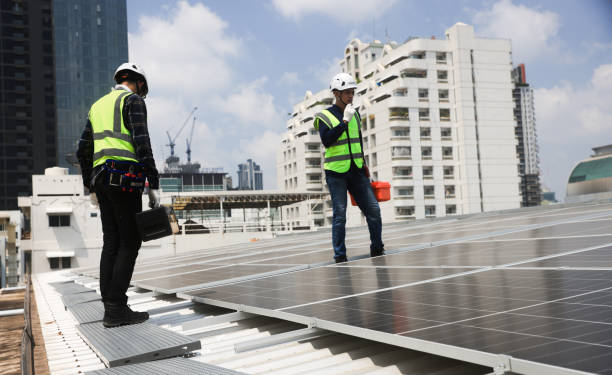 istock Two male Solar engineers working on the rooftop solar panel installations for quality assurance and maintenance. 2151164031