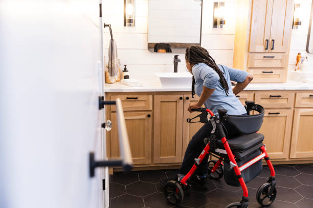 istock In bathroom, woman with disability stands up with rollator support 2151164787