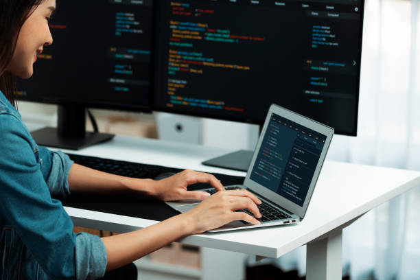 istock Smiling Asian IT typing online software development on laptop. Stratagem. 2151168264