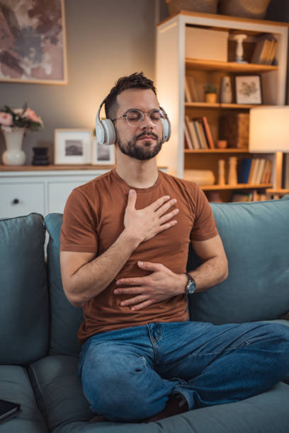 istock A young man with headphones sits on a bed and practices guided meditation 2151169381