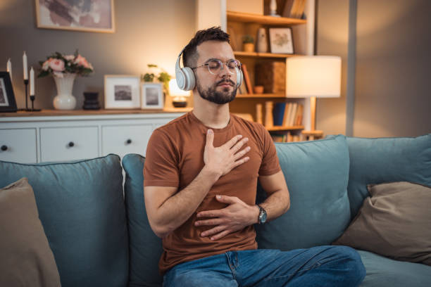 istock A young man with headphones sits on a bed and practices guided meditation 2151169390