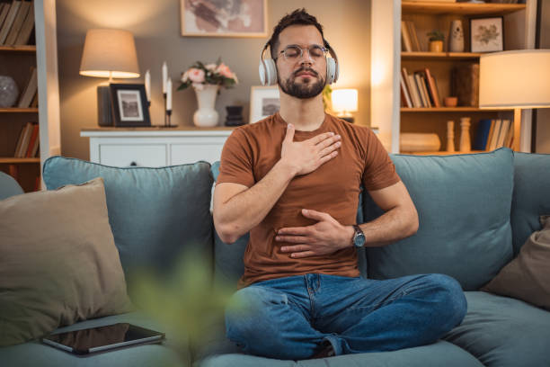 istock A young man with headphones sits on a bed and practices guided meditation 2151169395