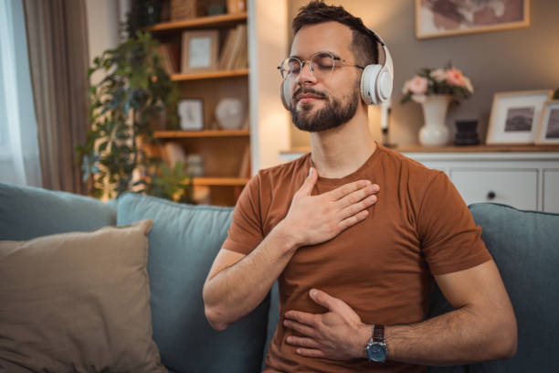 istock A young man with headphones sits on a bed and practices guided meditation 2151169397