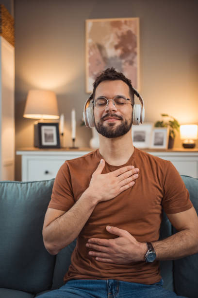 istock A young man with headphones sits on a bed and practices guided meditation 2151169399