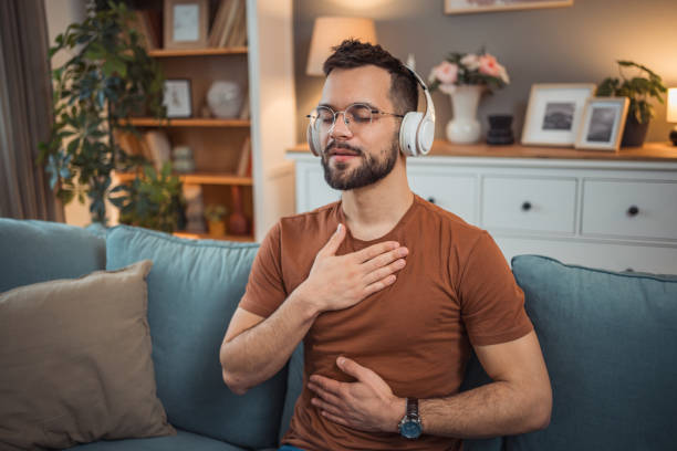 istock A young man with headphones sits on a bed and practices guided meditation 2151169400